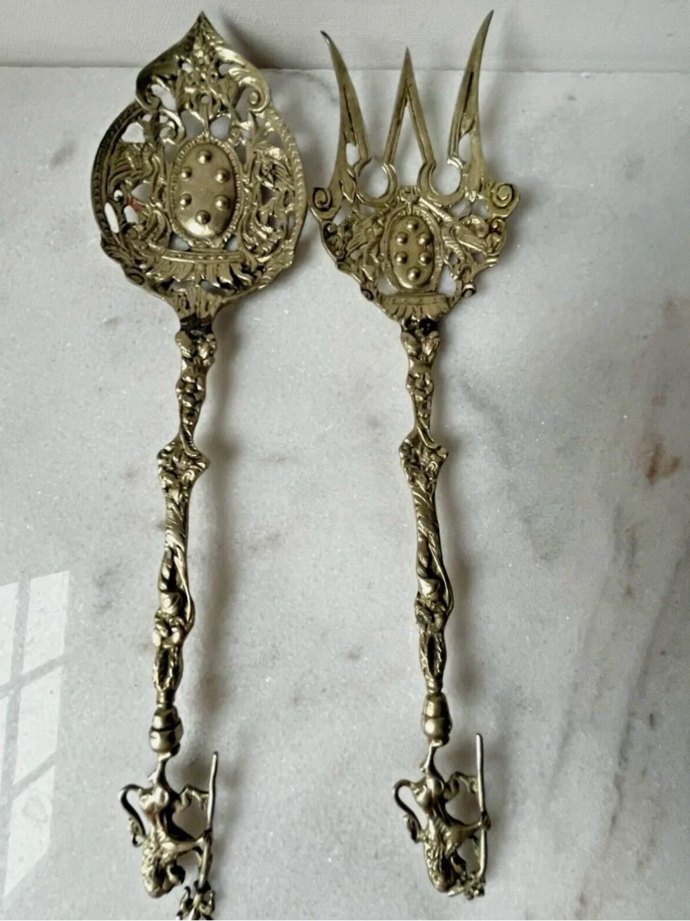 vintage Italian serving utensils are an ornate brass fork and spoon set